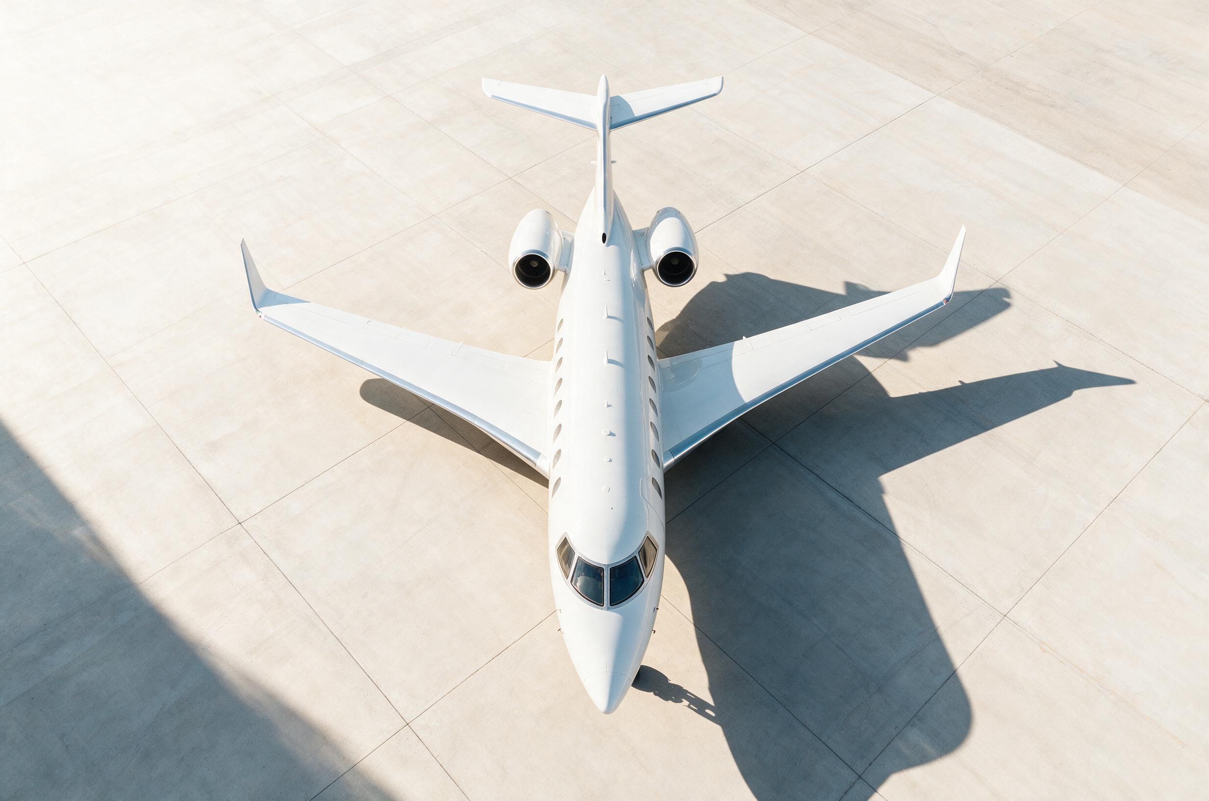 Private jet on illuminated tarmac at night